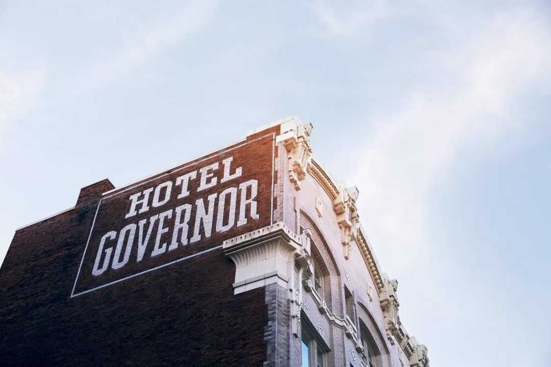Historic hotel sign on a brick building, merchant account for hotels and motels